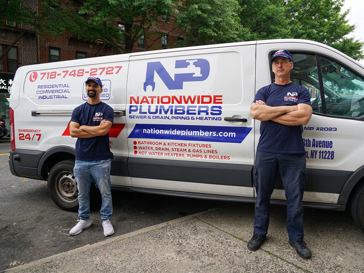 Nationwide Plumbers standing next to a van
